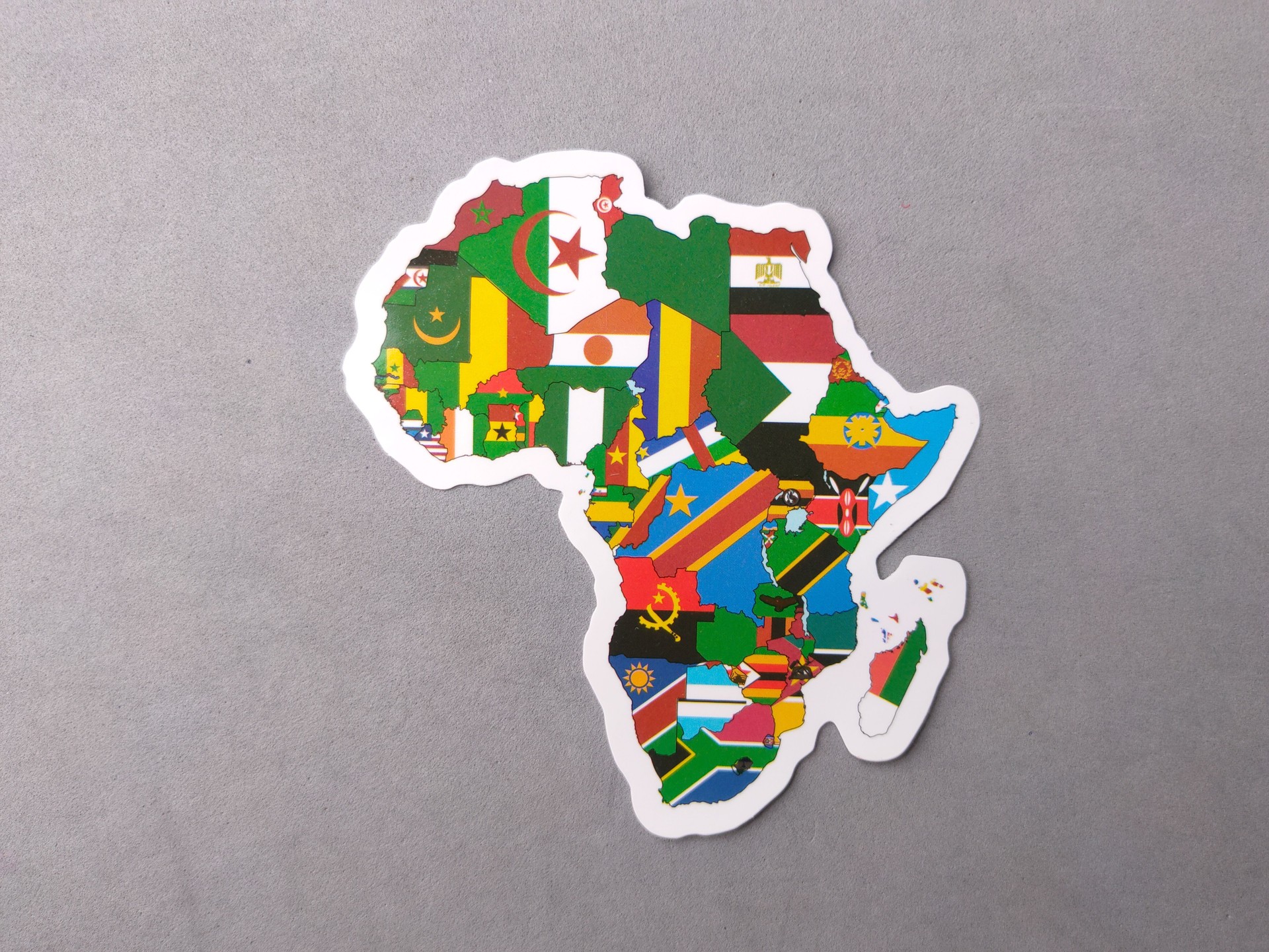 Top view of various national flags in one map on a gray background.